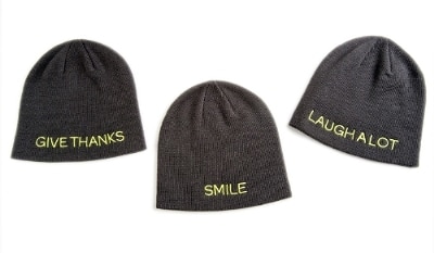 The Giving Hat™ is a stylish winter knit hat, one-size-fits-all and available in three versions embroidered with messages inspired by St. Jude patients and their families: "Smile," "Laugh A Lot," and "Give Thanks."