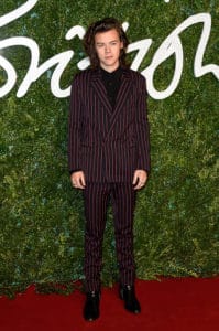 Harry Styles attends the British Fashion Awards at London Coliseum on December 2014 rocking red and black striped suit from Lanvin's fall-winter 2014 collection. Photo by: Pascal Le Segretain/Getty Images