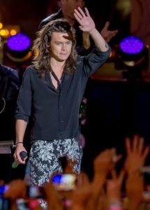 Harry performs with One Direction in the Jimmy Kimmel show wearing a black button-up shirt with black and white floral pants. Designer unknown. Photo by: Pacific Coast News /Barcroft Media
